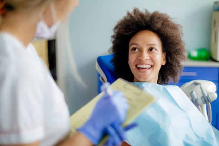 Happy dental patient speaking with a dentist during a clinic visit