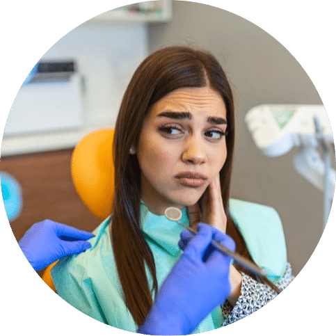 Patient holding their jaw while speaking with a dentist about tooth pain, highlighting compassionate emergency dental care, prompt diagnosis, and relief for dental discomfort.