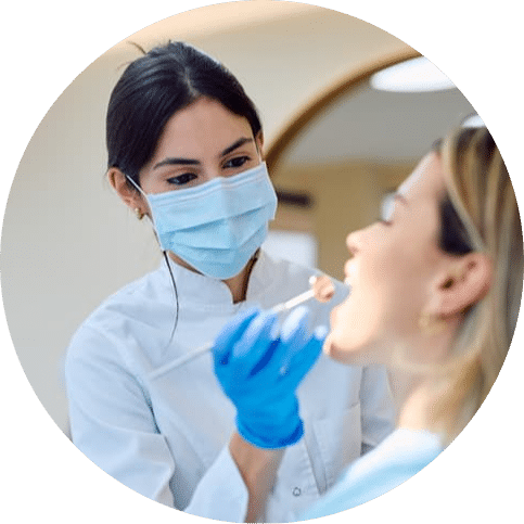 Dental professional performing a routine teeth cleaning on a patient in a modern clinic, supporting plaque removal, healthy gums, and preventive oral care.