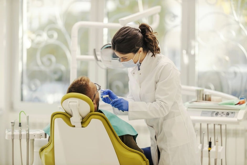 Dentist examining a patient during a dental appointment in a dental clinic in Edmonton